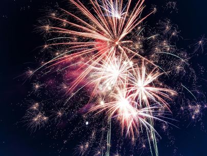 Colorful fireworks exploding in the night sky creating a festive atmosphere.