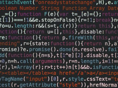 Close-up of colorful coding text on a dark computer screen, representing software development.